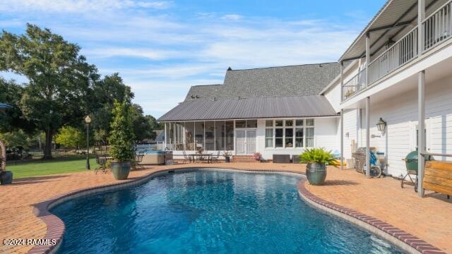 view of pool featuring a sunroom