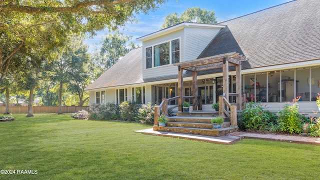 view of front facade featuring a pergola, a sunroom, and a front yard