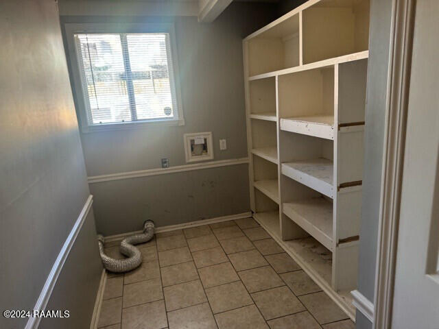 interior space featuring tile patterned flooring and hookup for a washing machine