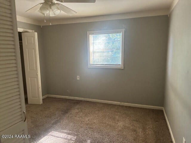 unfurnished bedroom with ceiling fan and carpet floors