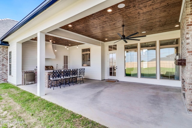 view of patio with outdoor wet bar, a sink, exterior kitchen, and ceiling fan