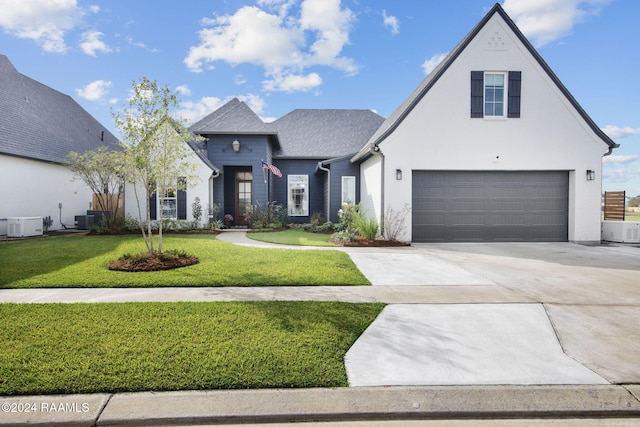 view of front of home with a front lawn and a garage