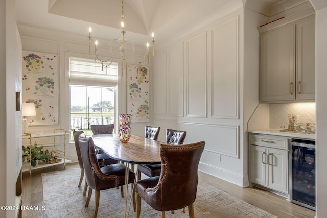 dining space featuring light hardwood / wood-style floors and wine cooler