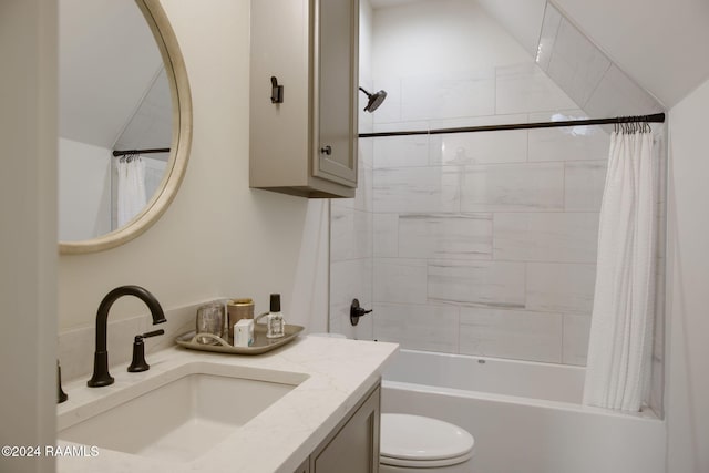 full bathroom featuring vanity, shower / bath combination with curtain, toilet, and vaulted ceiling