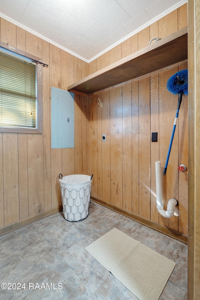 laundry room with wood walls and electric panel