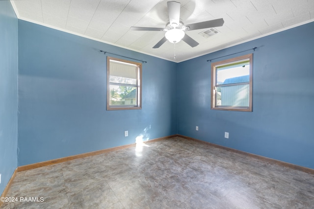 unfurnished room featuring ceiling fan and ornamental molding