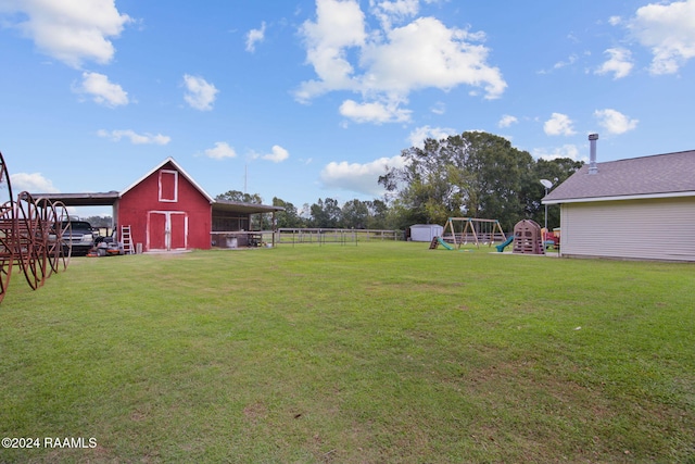 view of yard with a playground and an outdoor structure