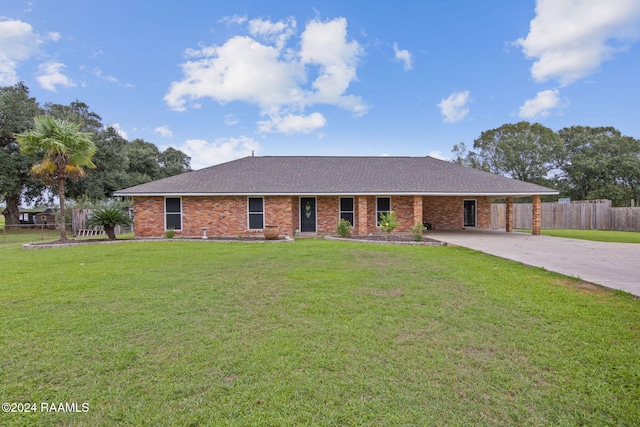 ranch-style house featuring a front lawn and a carport