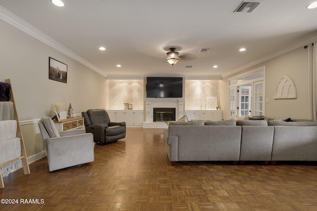 living room with dark parquet floors, ceiling fan, and ornamental molding