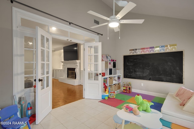 playroom with french doors, ceiling fan, light hardwood / wood-style flooring, and lofted ceiling