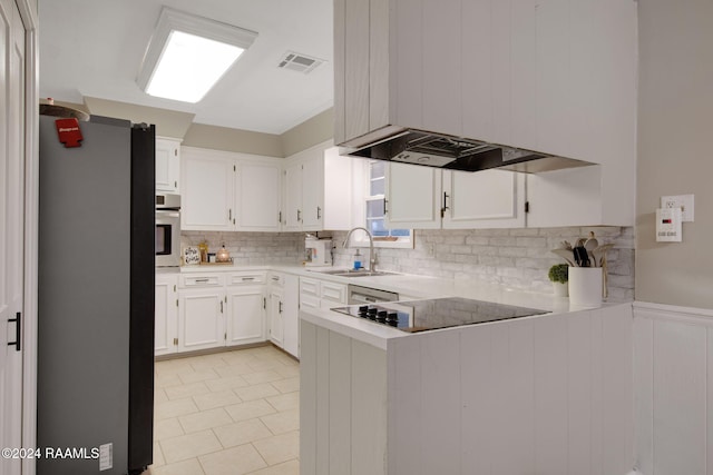 kitchen with kitchen peninsula, stainless steel appliances, white cabinets, and sink