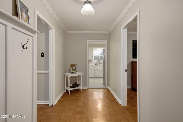 hall featuring ornamental molding, sink, and light parquet floors