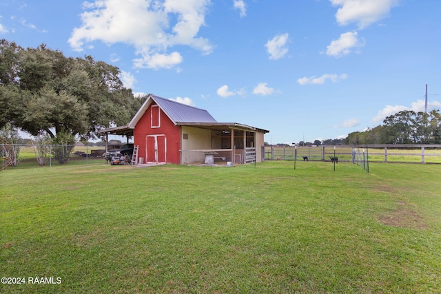 view of yard with a rural view and an outdoor structure