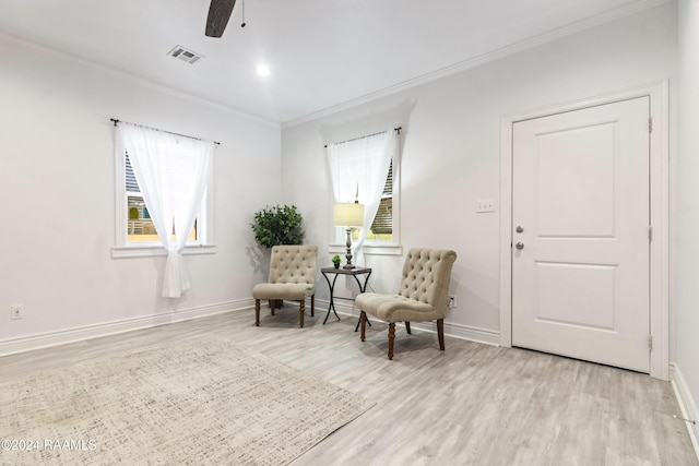 1036 Duhon Rd, Duson, LA 70529 - sitting room featuring crown molding, light wood-style floors, a ceiling fan, plenty of natural light, and baseboards