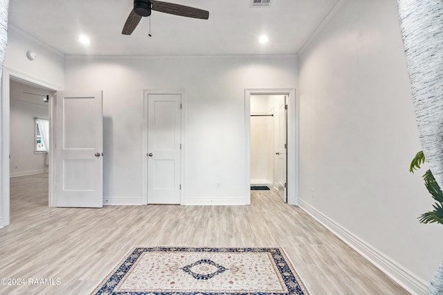 unfurnished bedroom with ceiling fan, light hardwood / wood-style floors, ornamental molding, and connected bathroom