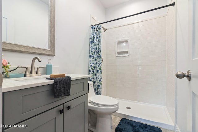 bathroom with curtained shower, vanity, hardwood / wood-style flooring, and toilet