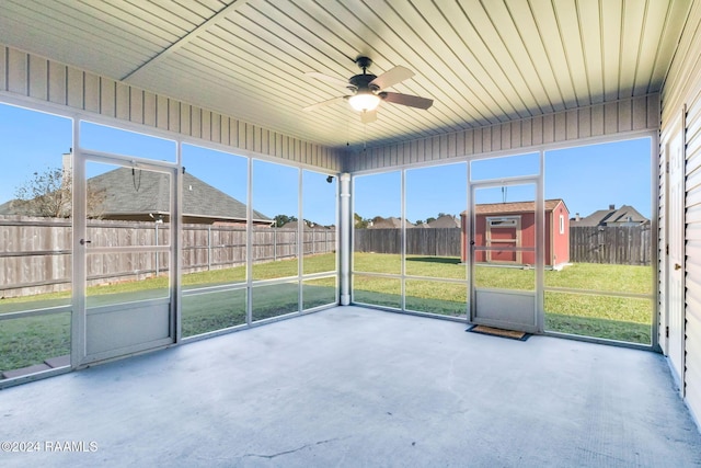 unfurnished sunroom featuring ceiling fan