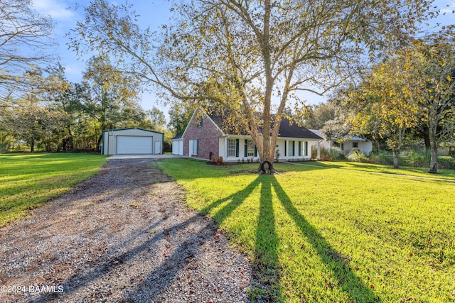 ranch-style home with a garage, an outbuilding, and a front yard