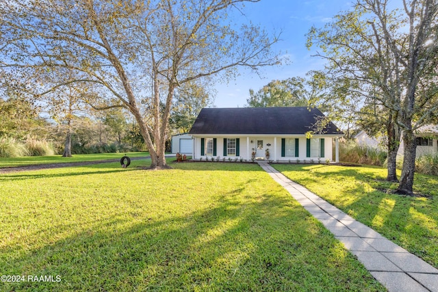 view of front of property with covered porch, a garage, and a front yard