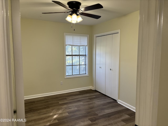141 Hummingbird Ln, Lafayette, LA 70506 - unfurnished bedroom featuring dark wood-style floors, baseboards, a closet, and a ceiling fan