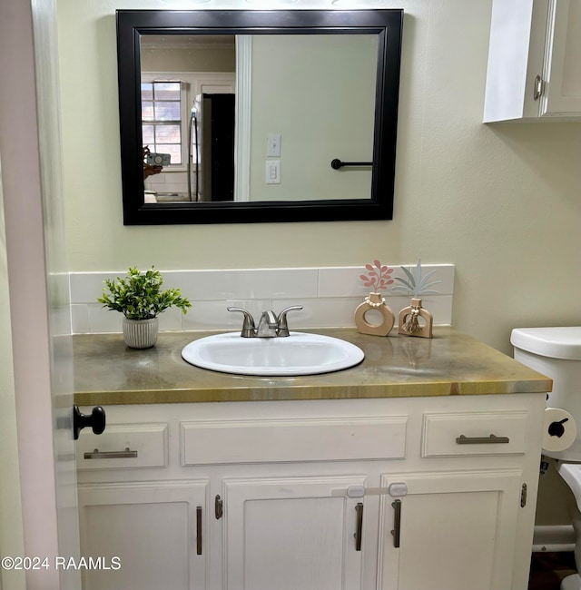 bathroom featuring vanity and toilet