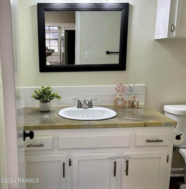 141 Hummingbird Ln, Lafayette, LA 70506 - half bathroom featuring vanity and toilet