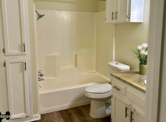 full bathroom with shower / washtub combination, vanity, wood-type flooring, and toilet