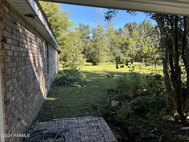 141 Hummingbird Ln, Lafayette, LA 70506 - view of grassy yard featuring view of wooded area