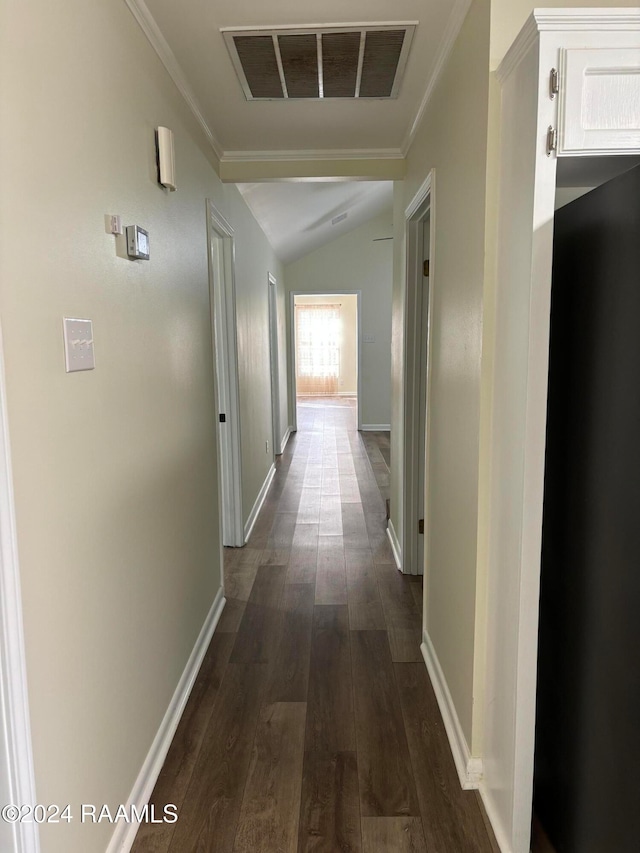 hall featuring crown molding, dark wood-type flooring, and vaulted ceiling