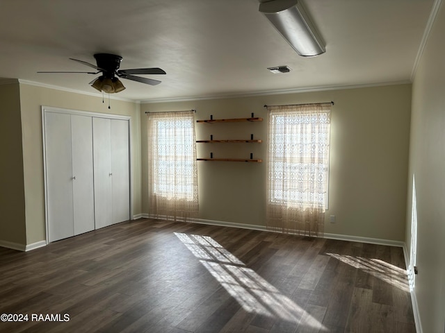 unfurnished bedroom with ceiling fan, a closet, dark hardwood / wood-style floors, and ornamental molding