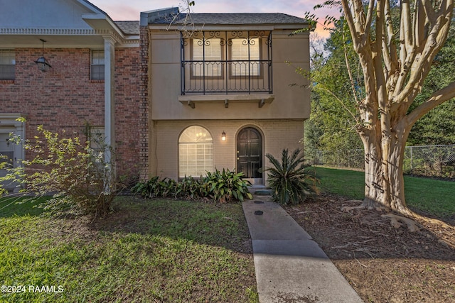 1316 Dulles Dr Apt H, Lafayette, LA 70506 - view of front of home featuring a balcony, brick siding, and stucco siding