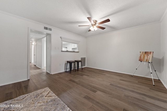 spare room with dark hardwood / wood-style floors, ceiling fan, and ornamental molding