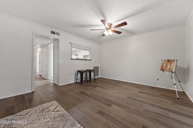 1316 Dulles Dr Apt H, Lafayette, LA 70506 - spare room featuring ceiling fan, wood finished floors, ornamental molding, baseboards, and a textured ceiling