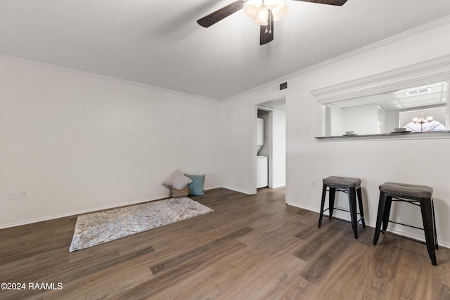 living room featuring dark hardwood / wood-style floors, ceiling fan, and crown molding