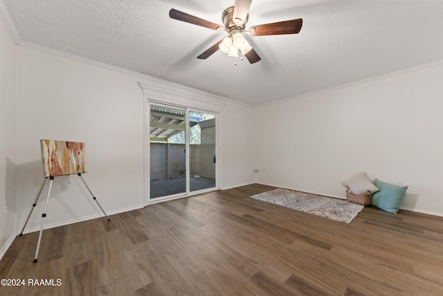 empty room featuring dark hardwood / wood-style floors, ceiling fan, ornamental molding, and a textured ceiling