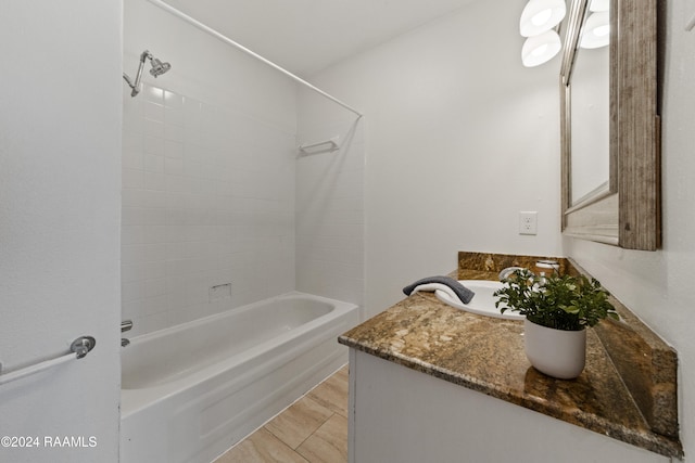 bathroom featuring bathing tub / shower combination, vanity, and wood-type flooring