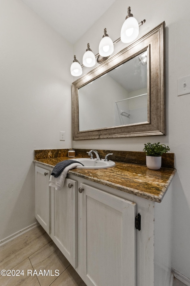 bathroom with vanity and hardwood / wood-style flooring