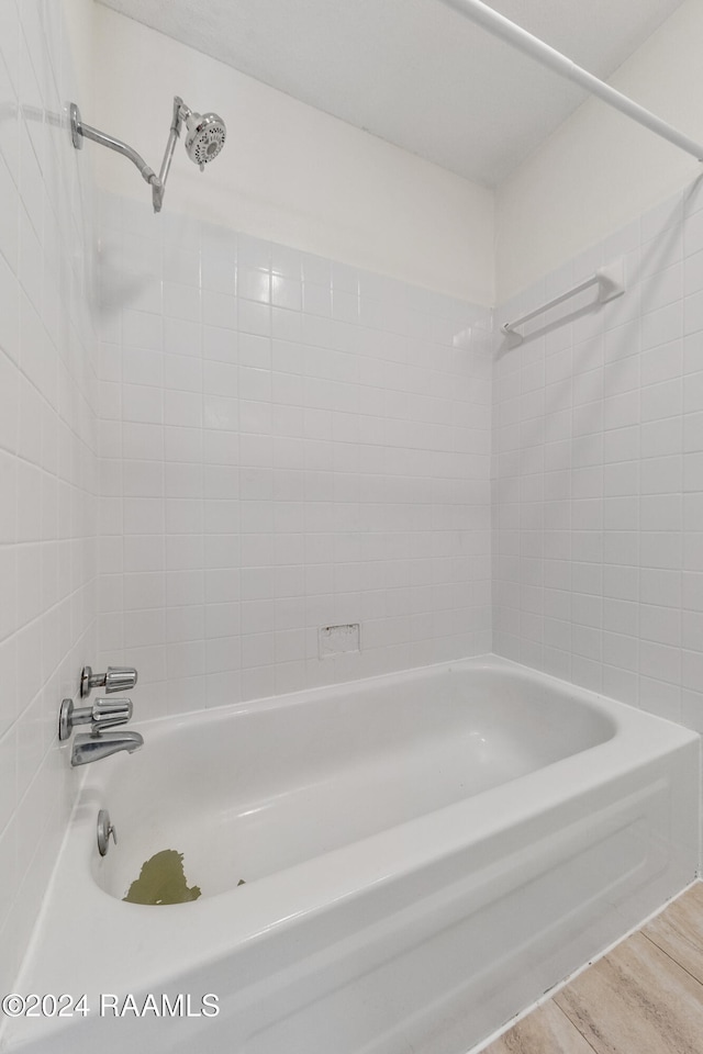 bathroom featuring hardwood / wood-style floors and tiled shower / bath