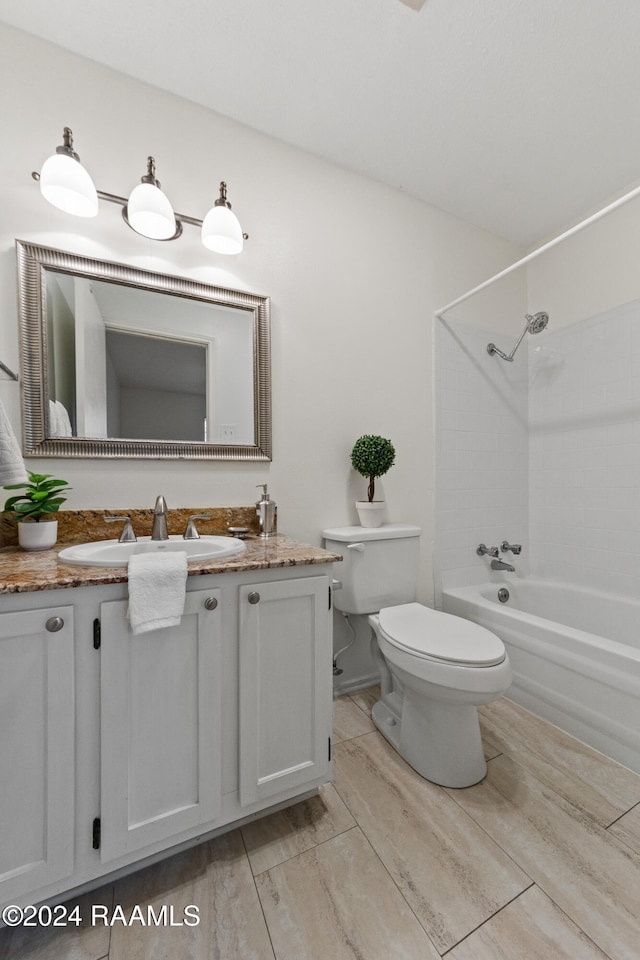 full bathroom with shower / bathing tub combination, vanity, hardwood / wood-style flooring, and toilet