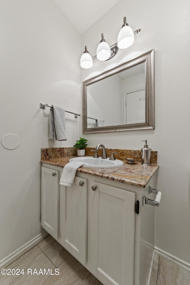 bathroom featuring tile patterned flooring and vanity