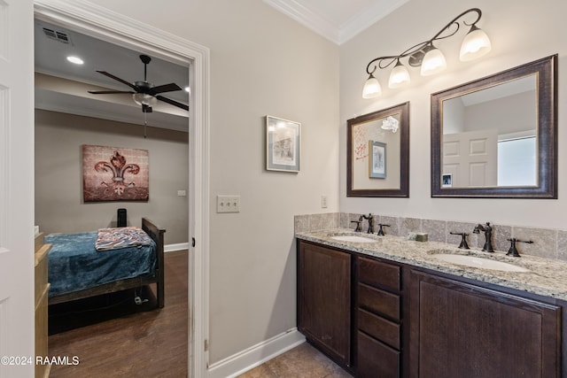 bathroom featuring tile patterned floors, vanity, crown molding, and ceiling fan