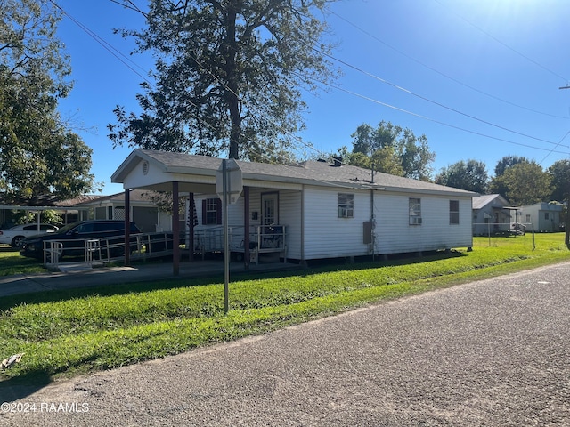 view of front of home with covered porch and a front yard