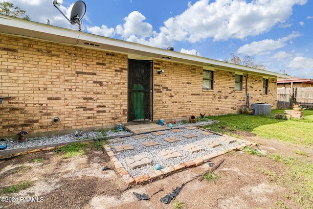 back of property featuring central AC