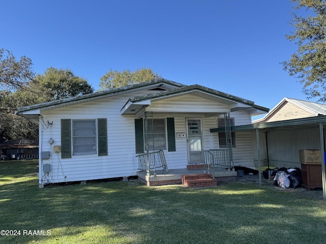 bungalow featuring covered porch and a front lawn