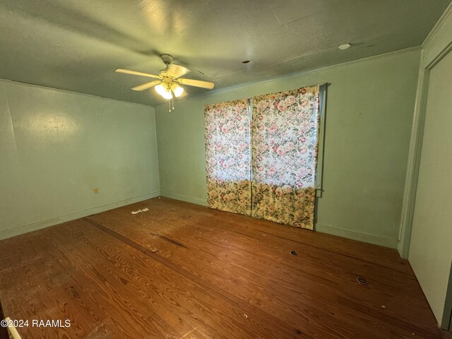 spare room with hardwood / wood-style flooring and ceiling fan