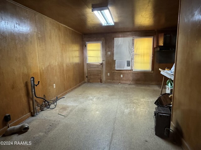 interior space with wooden walls and cooling unit