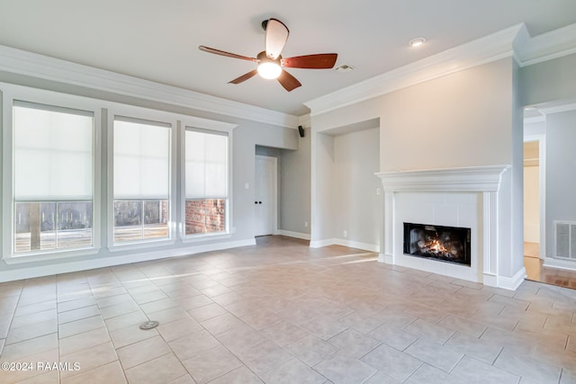 unfurnished living room with a tiled fireplace, ceiling fan, light tile patterned flooring, and ornamental molding