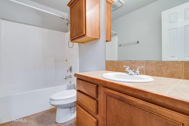 full bathroom with washtub / shower combination, tile patterned flooring, backsplash, toilet, and vanity