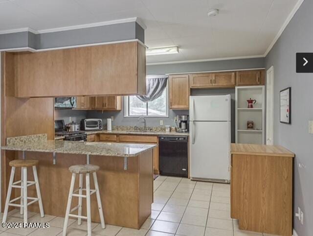 kitchen with a kitchen bar, stainless steel appliances, light stone counters, and ornamental molding