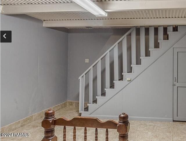 staircase featuring beamed ceiling